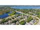 Scenic aerial shot of a residential neighborhood featuring charming houses, tranquil lakes, and green spaces in a peaceful setting at 6761 Scimitar Ave, Orlando, FL 32812