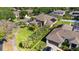 A landscape aerial view showcasing a spacious home, lush lawn, and a detached garage at 6761 Scimitar Ave, Orlando, FL 32812