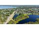 Breathtaking aerial view capturing a community with beautiful homes, sparkling lakes, and verdant landscaping on a sunny day at 6761 Scimitar Ave, Orlando, FL 32812
