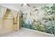 Spacious bedroom featuring an eye-catching jungle-themed mural, neutral carpet, and an open closet at 6761 Scimitar Ave, Orlando, FL 32812