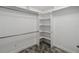 Walk-in closet with built-in shelving and rods for storage, showcasing an organized space at 6761 Scimitar Ave, Orlando, FL 32812