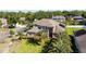 An aerial view showing a beautiful two-story home with a well-manicured lawn and mature palm trees at 6761 Scimitar Ave, Orlando, FL 32812