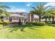 Beautiful home exterior with a well-manicured lawn, mature landscaping, and an inviting architectural style at 6761 Scimitar Ave, Orlando, FL 32812