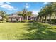 Stunning home showcasing immaculate landscaping, a lush lawn, and elegant architectural design at 6761 Scimitar Ave, Orlando, FL 32812