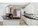 Modern kitchen with white cabinets, granite countertops, and designer backsplash at 6761 Scimitar Ave, Orlando, FL 32812