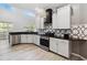 Well-lit kitchen with black countertops, stainless steel appliances, and white cabinets at 6761 Scimitar Ave, Orlando, FL 32812