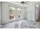 Bright living room with marble floors, arched windows, and high ceilings, showcasing a modern aesthetic at 6761 Scimitar Ave, Orlando, FL 32812