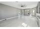 Open-concept living room bathed in natural light, complemented by stylish tiled flooring and a cozy fireplace at 6761 Scimitar Ave, Orlando, FL 32812