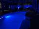 Inviting swimming pool illuminated by colorful lights, perfect for evening relaxation and entertainment at 6761 Scimitar Ave, Orlando, FL 32812