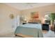 Cozy bedroom with a plush bed, neutral carpet, and calming decor with art and ceiling fan at 692 Seabrook Ct # 103, Altamonte Springs, FL 32714