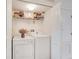 Practical laundry area with washer, dryer, and storage shelving for convenience and organization at 692 Seabrook Ct # 103, Altamonte Springs, FL 32714