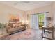 Comfortable living room with a plush sofa, colorful rug, and access to a patio at 692 Seabrook Ct # 103, Altamonte Springs, FL 32714