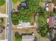 Bird's-eye view of a cozy home nestled amongst mature trees, with a well-maintained yard and quaint surroundings at 80 Lombardy Rd, Winter Springs, FL 32708