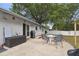 Back patio features a stone table with chairs, perfect for outdoor dining and gatherings at 80 Lombardy Rd, Winter Springs, FL 32708