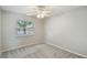 Cozy carpeted bedroom with neutral walls, bright natural light, and a ceiling fan at 80 Lombardy Rd, Winter Springs, FL 32708