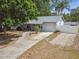 Charming home with updated grey roof, a driveway, and a partial privacy fence at 80 Lombardy Rd, Winter Springs, FL 32708