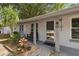 Inviting front porch area with seating, plants, a brick pathway, and the house number displayed at 80 Lombardy Rd, Winter Springs, FL 32708