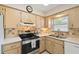 Functional kitchen featuring a stainless steel range, ample cabinetry, and a window for natural light at 80 Lombardy Rd, Winter Springs, FL 32708