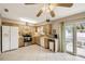 Spacious eat-in kitchen with bright cabinetry, stainless appliances, and a sliding glass door to the outside at 80 Lombardy Rd, Winter Springs, FL 32708