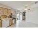Bright eat-in kitchen with cabinetry, white appliances, and access to the outside, plus a laundry closet at 80 Lombardy Rd, Winter Springs, FL 32708
