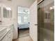 Bathroom with double sinks, large shower and view into the bedroom at 8180 Boat Hook Loop # 105, Windermere, FL 34786