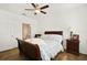 Comfortable bedroom with wood floors, fan, and ample natural light from the two large windows at 8180 Boat Hook Loop # 105, Windermere, FL 34786