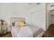Comfortable bedroom featuring a full-sized bed, stylish decor and laminate wood floors at 8180 Boat Hook Loop # 105, Windermere, FL 34786