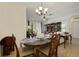 Formal dining room with elegant chandelier, tile floors, and a view into the living room at 8180 Boat Hook Loop # 105, Windermere, FL 34786