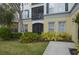 Exterior view of condo building featuring a patio with beautiful landscape at 8180 Boat Hook Loop # 105, Windermere, FL 34786