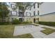 Exterior angle featuring an attractive common area, mature trees, and yellow tones of the exterior at 8180 Boat Hook Loop # 105, Windermere, FL 34786