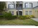 Inviting facade with manicured landscaping, a covered entrance, and charming architectural details at 8180 Boat Hook Loop # 105, Windermere, FL 34786