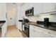 Well-equipped kitchen boasts stainless steel appliances, granite countertops, and ample storage space at 8180 Boat Hook Loop # 105, Windermere, FL 34786