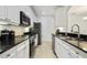 Modern kitchen with sleek black countertops, stainless steel appliances, and ample cabinet space at 8180 Boat Hook Loop # 105, Windermere, FL 34786