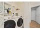 Laundry room features modern washer and dryer units, storage shelves, and louvered doors at 8180 Boat Hook Loop # 105, Windermere, FL 34786