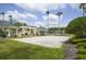Sand volleyball court surrounded by green landscaping, gazebos and palm trees under a sunny sky at 8180 Boat Hook Loop # 105, Windermere, FL 34786