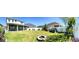 Backyard features a stone fire pit, a lawn, and a garden with a white fence at 8225 Corkfield Ave, Orlando, FL 32832