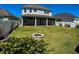 Expansive backyard featuring a screened lanai and a charming fire pit for outdoor entertaining at 8225 Corkfield Ave, Orlando, FL 32832