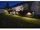 Backyard at night featuring a garden bed with accent lighting along the fence line at 8225 Corkfield Ave, Orlando, FL 32832