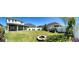Expansive backyard featuring a lush lawn, a cozy fire pit and providing an ideal space for recreation at 8225 Corkfield Ave, Orlando, FL 32832