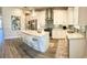 Bright kitchen boasts stainless appliances, an island with seating, and modern pendant lighting at 8225 Corkfield Ave, Orlando, FL 32832