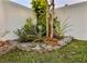 Landscaped backyard featuring vibrant plants, stone accents and lush lawn providing an inviting outdoor space at 8225 Corkfield Ave, Orlando, FL 32832