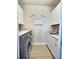 Well-equipped laundry room with modern appliances, granite counters and ample cabinet space at 8225 Corkfield Ave, Orlando, FL 32832