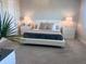 Spacious main bedroom with neutral décor, carpet flooring, and bedside tables with lamps at 8225 Corkfield Ave, Orlando, FL 32832