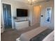 This spacious primary bedroom features a king bed, television, and ensuite bath at 8225 Corkfield Ave, Orlando, FL 32832