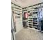 This large walk-in closet is fully organized with shelves, drawers, rods and cabinets at 8225 Corkfield Ave, Orlando, FL 32832