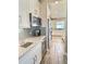 A stylish wet bar with stainless steel microwave and beverage cooler and designer tile backsplash at 8225 Corkfield Ave, Orlando, FL 32832