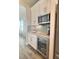 A stylish wet bar with stainless steel microwave and beverage cooler and designer tile backsplash at 8225 Corkfield Ave, Orlando, FL 32832