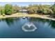 Stunning aerial view of home with private lake, fountain feature, dock, and expansive, tree-filled backyard at 835 Dyson Dr, Winter Springs, FL 32708