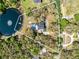 Aerial view of property showing the lake, parcel lines, pool, expansive tree coverage and privacy at 835 Dyson Dr, Winter Springs, FL 32708