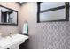 Stylish powder room featuring patterned wallpaper, a modern sink, and updated fixtures at 835 Dyson Dr, Winter Springs, FL 32708